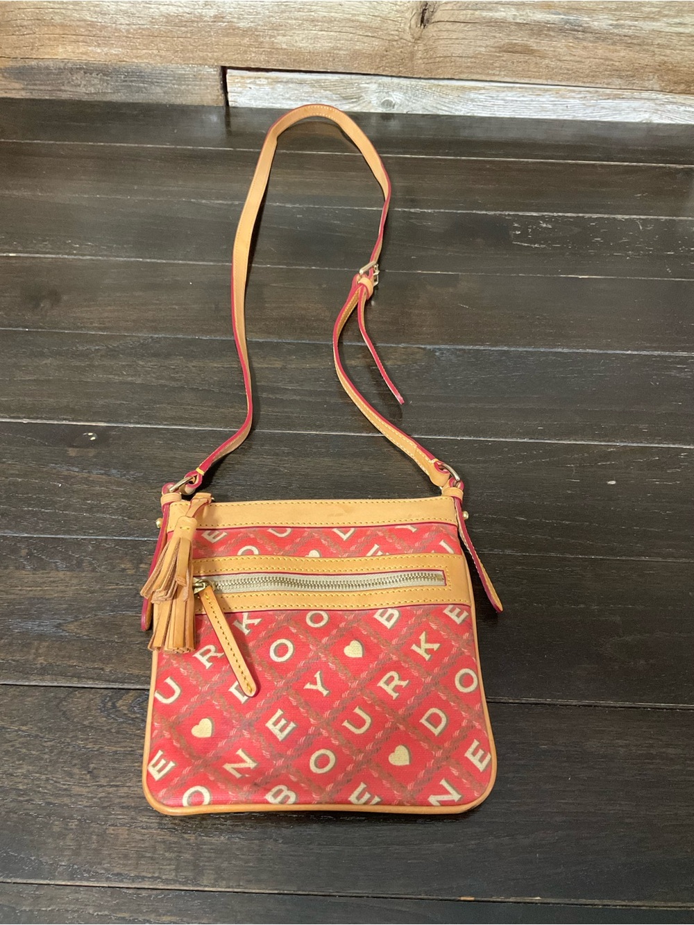 Dooney & Bourke red and tan coated canvas cross bag.